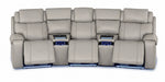 Velocity light grey home theatre seating front view with extended footrests, illuminated consoles and base lighting